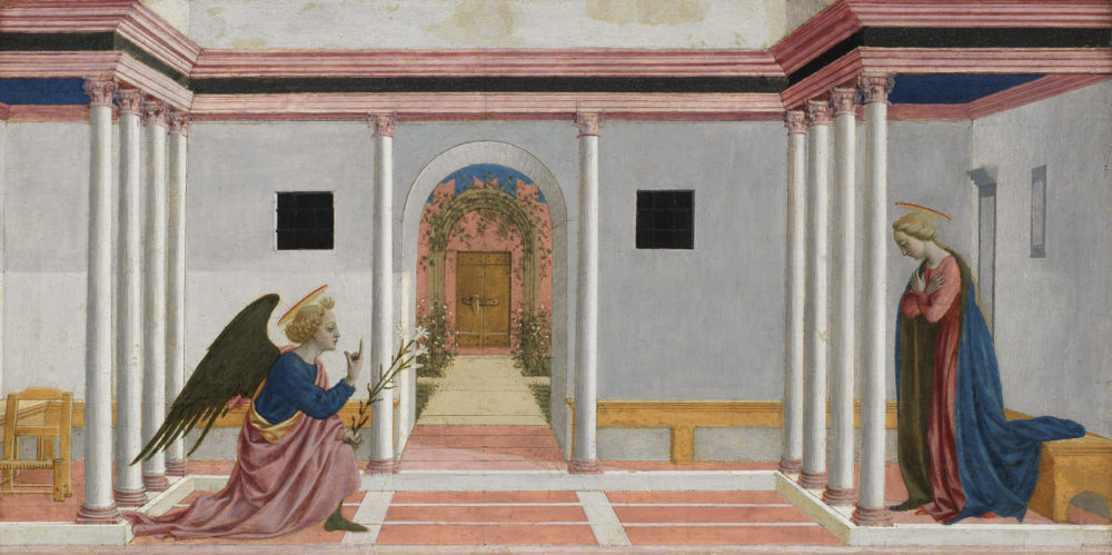 A painting of a room with a pink floor and grey-white walls. An angel kneels and points upwards, holding a flower, in the direction of the Virgin Mary, a woman in blue with a halo over her head.