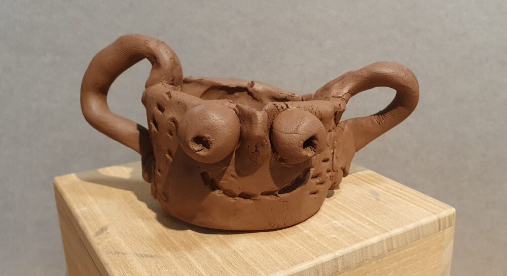 A student's clay cup in the style of an ancient Greek skyphos