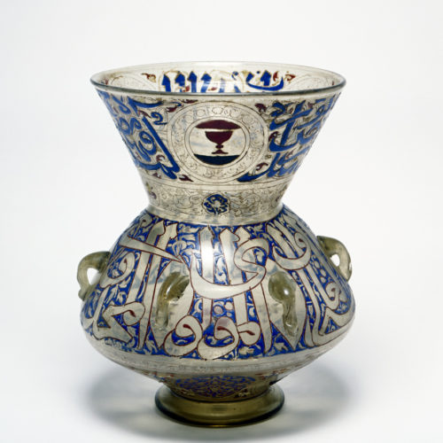 a glass mosque lamp decorated with blue, and red calligraphy and symbols