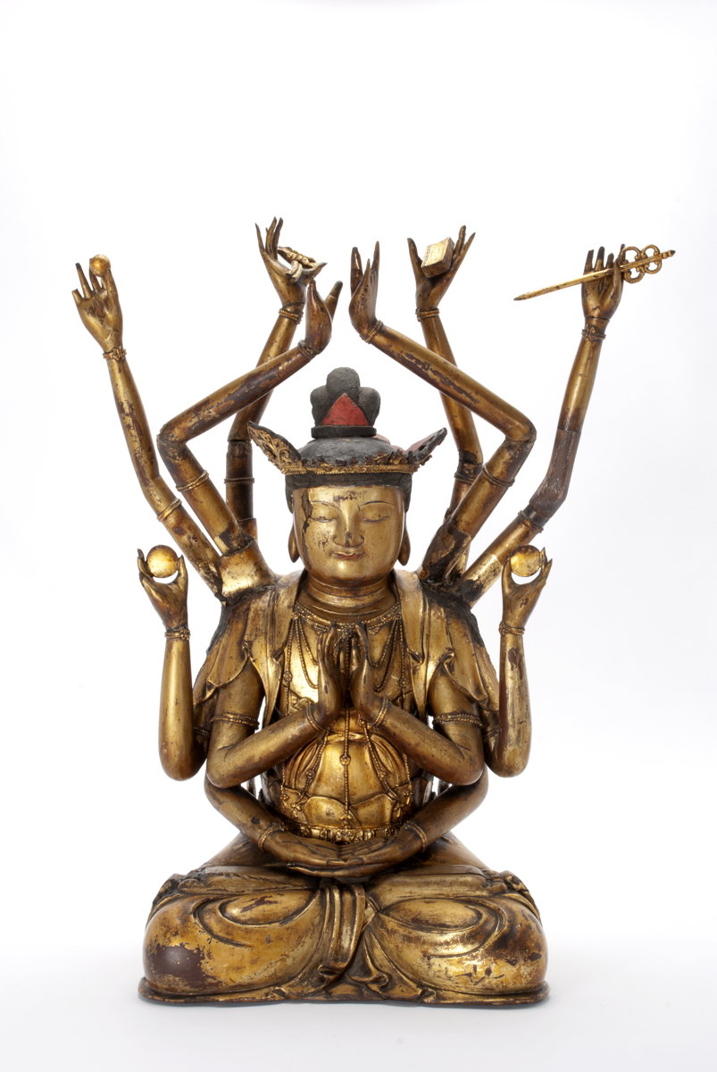A carbved wooden figure of Guanyin the God(dess) of Mercy covered in gold lacquer