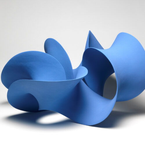 A photograph of a blue sculpture which twists and turns around in a circle. It is a mobius strip.