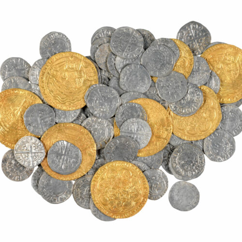A photograph of the Cambridge hoard: a pile of many silver pennies and nine larger gold coins.